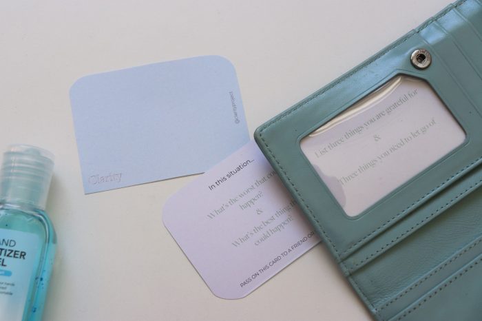 Coloured cards with a wallet and sanitiser