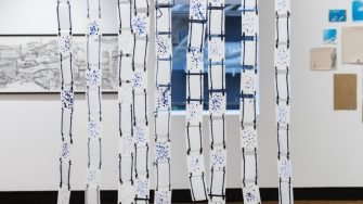 Fatima Naqvi, ‘Blind Faith’ (2025). Blue ink stamped with prayer bead on 99 A7 panels joined together using eyelet rings and blue thread; 94.5cm x 81.4cm. Photograph: Anna Kucera.