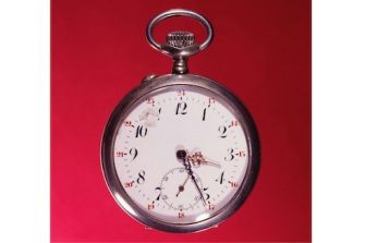 A promotional image for Sigi Jottkandt's 2026 Literary Provocations Hub seminar. It shows a silver timepiece on a red background.