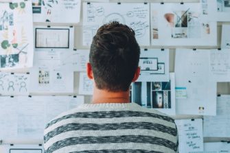 looking at a wall of papers