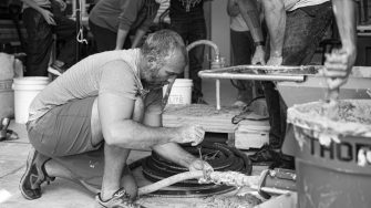 A researcher works on a portable 3D concrete printer.