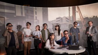 Students and teacher operate learning in a virtual reality cinema.