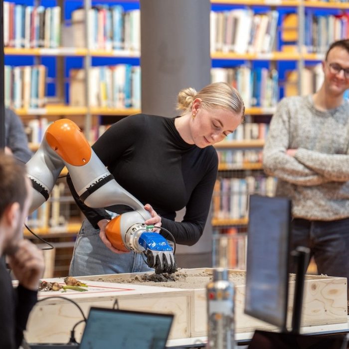 Charlotte Firth with robotic arm