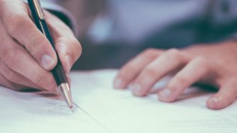 Man writing on paper banner