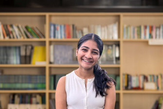 Photo of Neomi Verma against a Library Backdrop