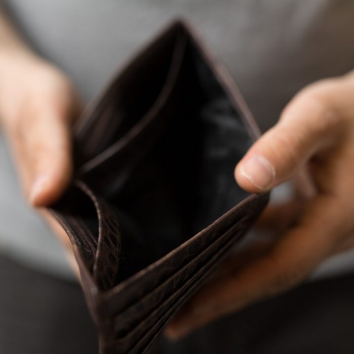 person holding open empty wallet