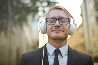 A person smiles wearing headphones