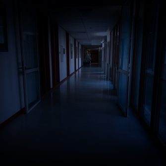 Dark empty corridor in hospital building at night