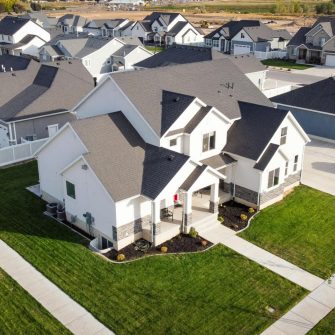 Aerial view of suburban houses with black roofs