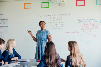 Female teacher discussing STEM: Mathematics during class.