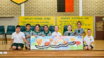 children showcasing an artwork