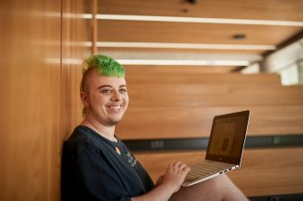 Art and design students discussing work inside the Red Center build enviroment study space.
