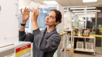 Female ADA student examines a 3D printed item