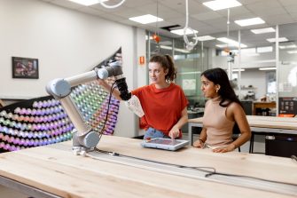 Students in Design Futures Lab with robotic arm