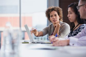 Peers having serious conversation in classroom