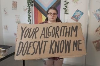 Person holding sign that says, "Your algorithm doesn't know me."