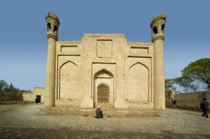 Man prays in front of the Mazar of Chiltän. Yarkand, Xinjiang