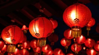 Rows of colorful glowing red Chinese lanterns hanging high at temple ground during Chinese New Year Celebrations at Thean Hou Temple, Kuala Lumpur Malaysia.