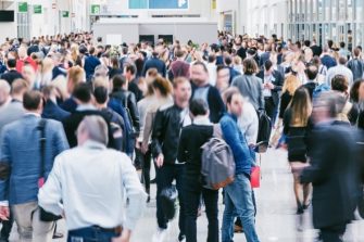 Large crowd of business people walking in a convention centre floor