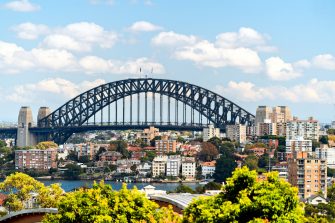 A station platform in Ealing, West London, full of passengers waiting for a train into the city centre.