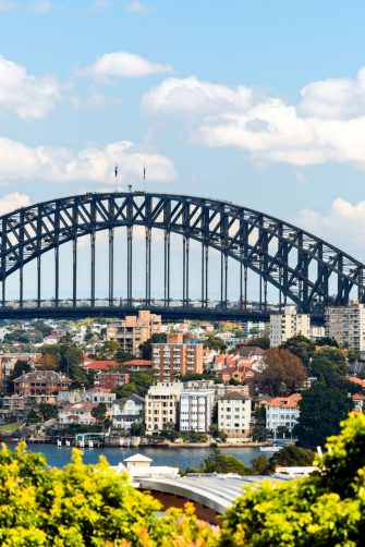A station platform in Ealing, West London, full of passengers waiting for a train into the city centre.