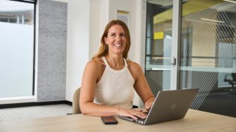 AGSM students working together from a laptop in a classroom on campus