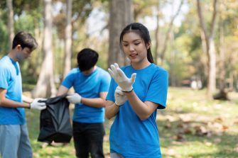 A volunteer prepares to participate in a park cleanup, highlighting the importance of sustainability and teamwork.