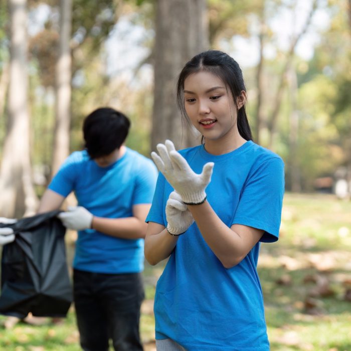 A volunteer prepares to participate in a park cleanup, highlighting the importance of sustainability and teamwork.