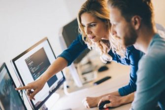 Two people collaborating on a desktop