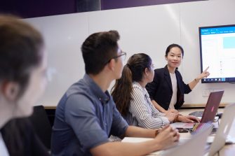 Students and teachers in business school computer lab