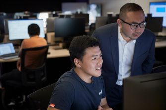 Students studying on computers in the business school computer lab.