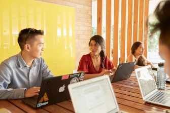 Students relaxing with computers, talking and studying at Kensington UNSW
