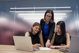 Post graduate students working on computers, talking and studying at the business school, Kensington UNSW
