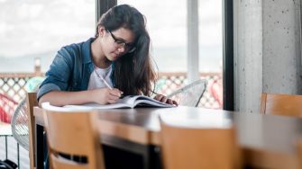 Women writing on a book