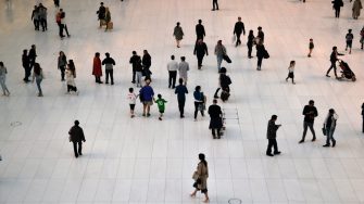 People walking around on white tiles