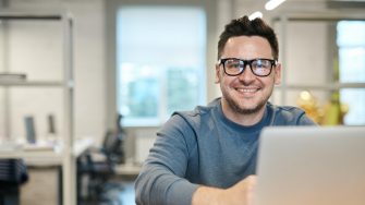 Man smiling over laptop