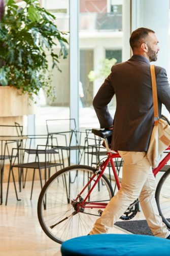 Shot of a businessman with his bicycle going home after work from office