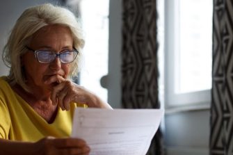 mature woman reading paperwork
