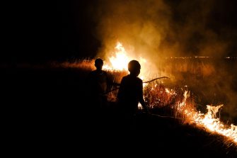 Indigenous Australians with a fire in a remote community.