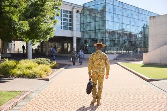 ADFA Canberra UNSW army student with bag walking towards building
