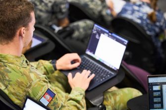 ADFA Canberra UNSW male army student in lecture with laptop