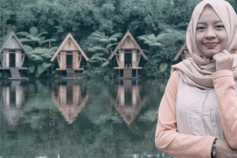 Lady in front of lake cottages