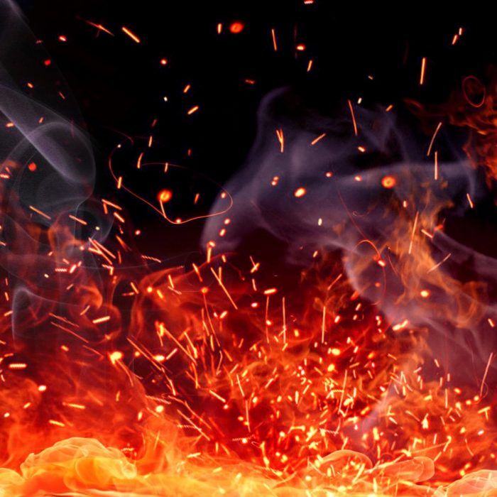 Firestorm texture. Bokeh lights on black background, shot of flying fire sparks in the air