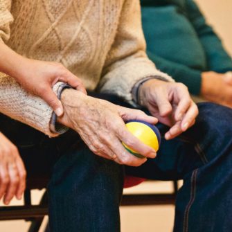 Elderly man holding a ball
