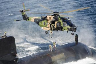 Helicopter airlifting military personnel