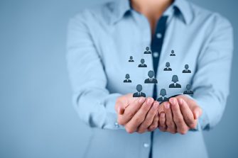 Graphic depicting business person with people avatars  in hand