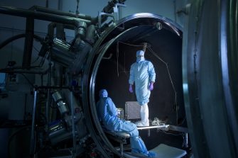 Engineers from the UNSW Canberra Space team work at the National Space Test Facility at Mt Stromlo during testing for the M2 mission.