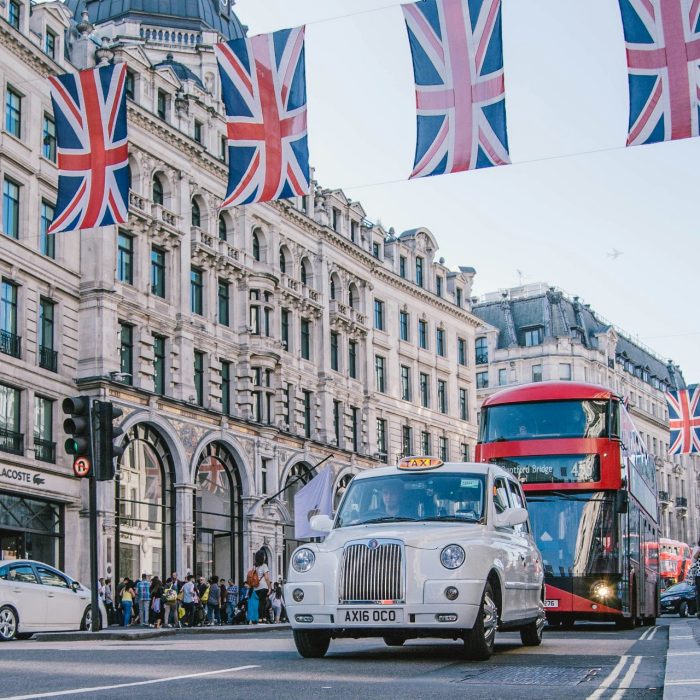 A taxi and bus on a street in London