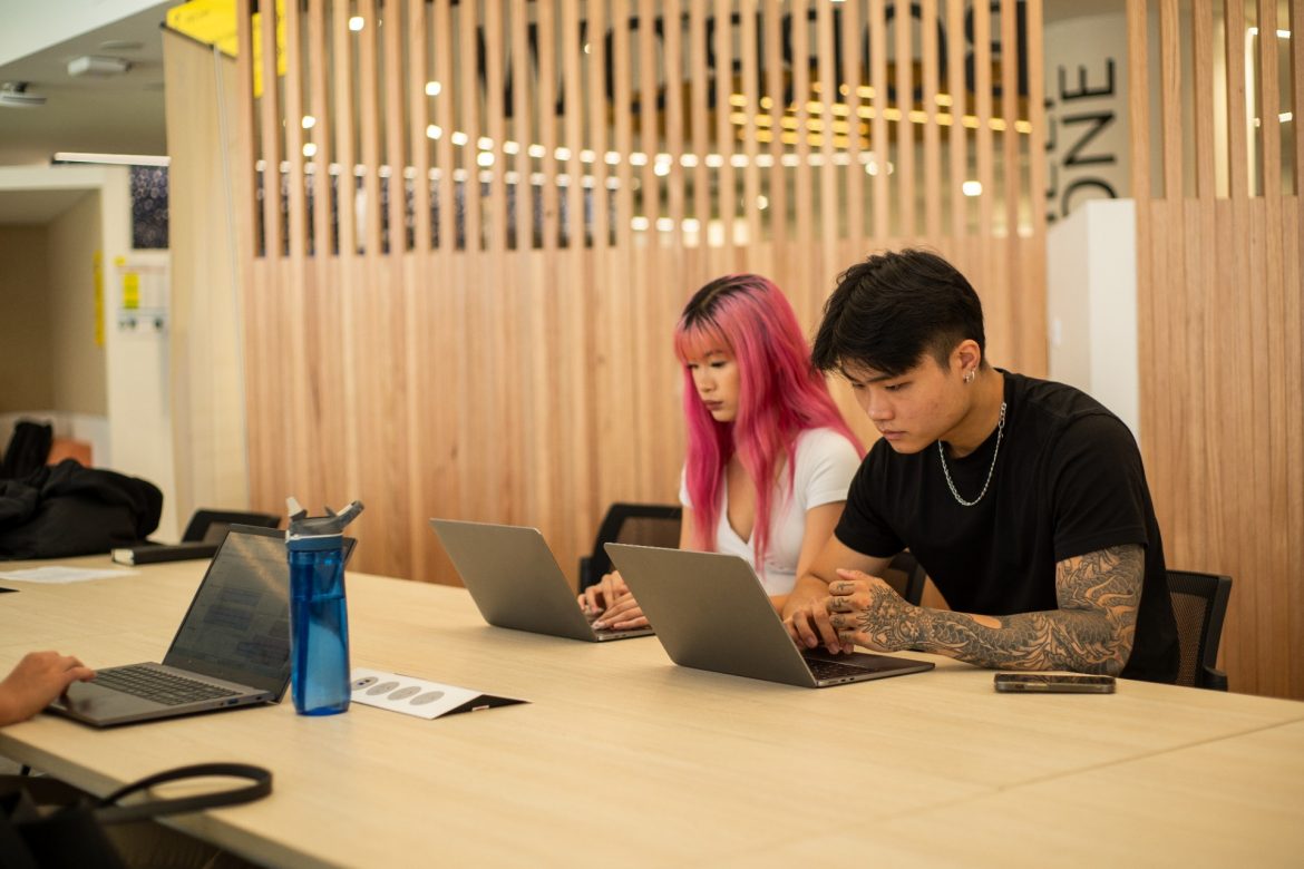 Students with their laptops in the Paddington Library