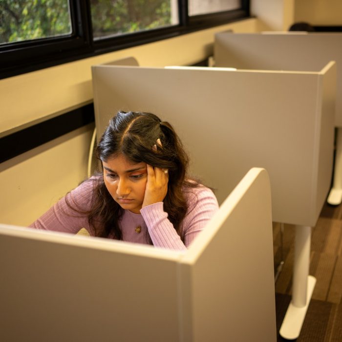 A student at a desk in the library